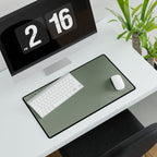 Minimal Green medium-format desk mat beneath a white keyboard and mouse, viewed at an angle.