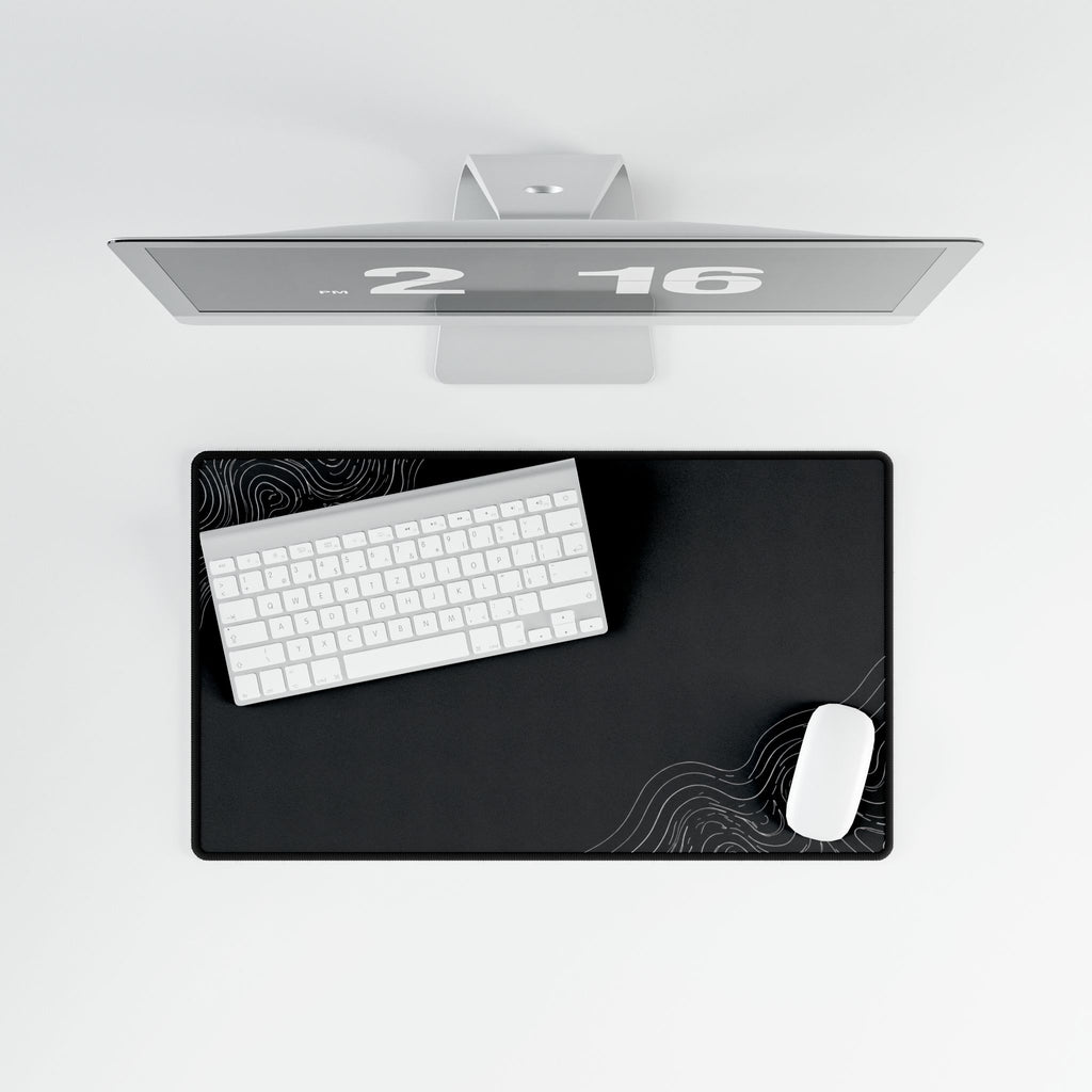 Overhead view of Minimal Charcoal medium-format desk mat on a white desk.
