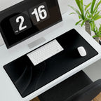 Printify preview: Graphite Fold, 31.5 × 15.5 inches, angled desk view with keyboard and mouse.