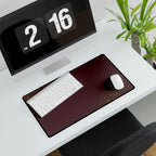 Minimal Burgundy medium-format desk mat beneath a white keyboard and mouse, viewed at an angle.