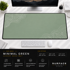 Minimal Green desk mat beneath a monitor on a bright desk with a white keyboard and mouse.