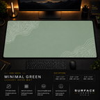 Minimal Green desk mat in a dark workstation with a keyboard, mouse and warm monitor lighting.