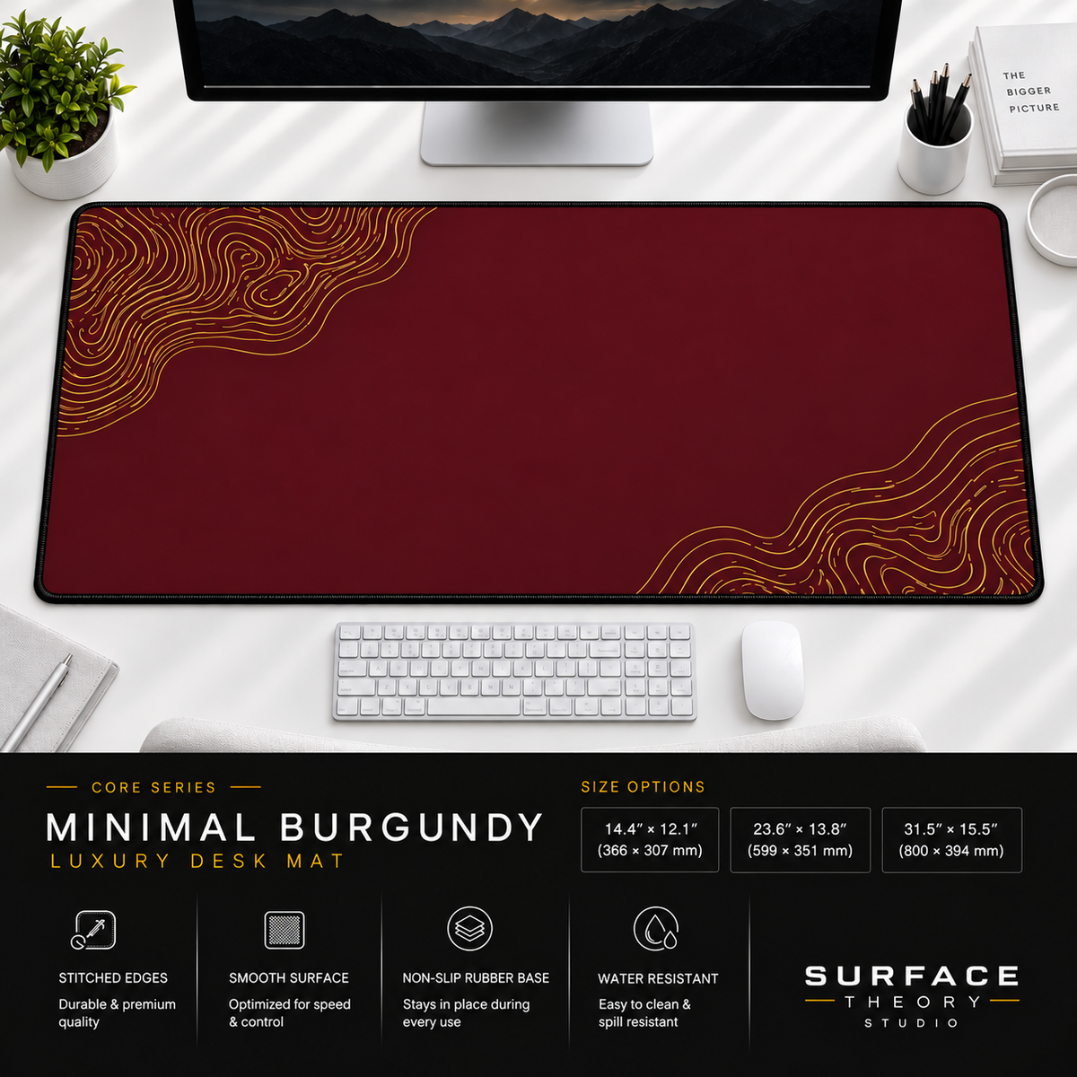 Minimal Burgundy desk mat beneath a monitor on a bright desk with a white keyboard and mouse.