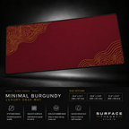 Minimal Burgundy desk mat floating against a dark studio background.