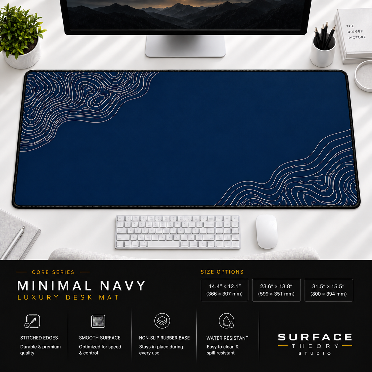 Minimal Navy desk mat beneath a monitor on a bright desk with a white keyboard and mouse.