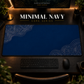 Minimal Navy desk mat with pale contour lines on navy blue, shown in a warm, dark desk setup.