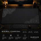 Minimal Charcoal desk mat in a dark workstation with a keyboard, mouse and warm monitor lighting.