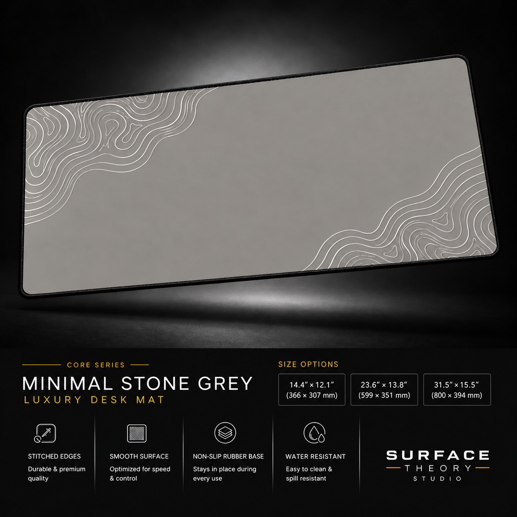 Minimal Stone Grey desk mat floating against a dark studio background.