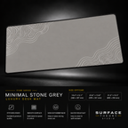 Minimal Stone Grey desk mat floating against a dark studio background.