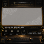 Minimal Stone Grey desk mat in a gold-toned display frame above a keyboard.