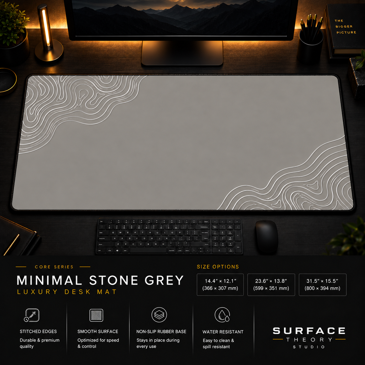 Minimal Stone Grey desk mat in a dark workstation with a keyboard, mouse and warm monitor lighting.