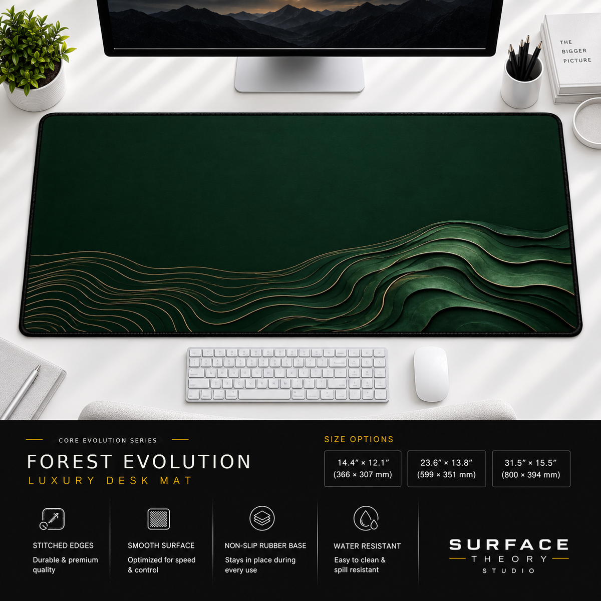 Forest Evolution desk mat beneath a monitor on a bright desk with a white keyboard and mouse.