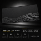 Charcoal Evolution desk mat floating against a dark studio background.