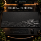 Charcoal Evolution desk mat, charcoal grey with silver-grey contours widening into layered curves, in a warm, dark workspace.