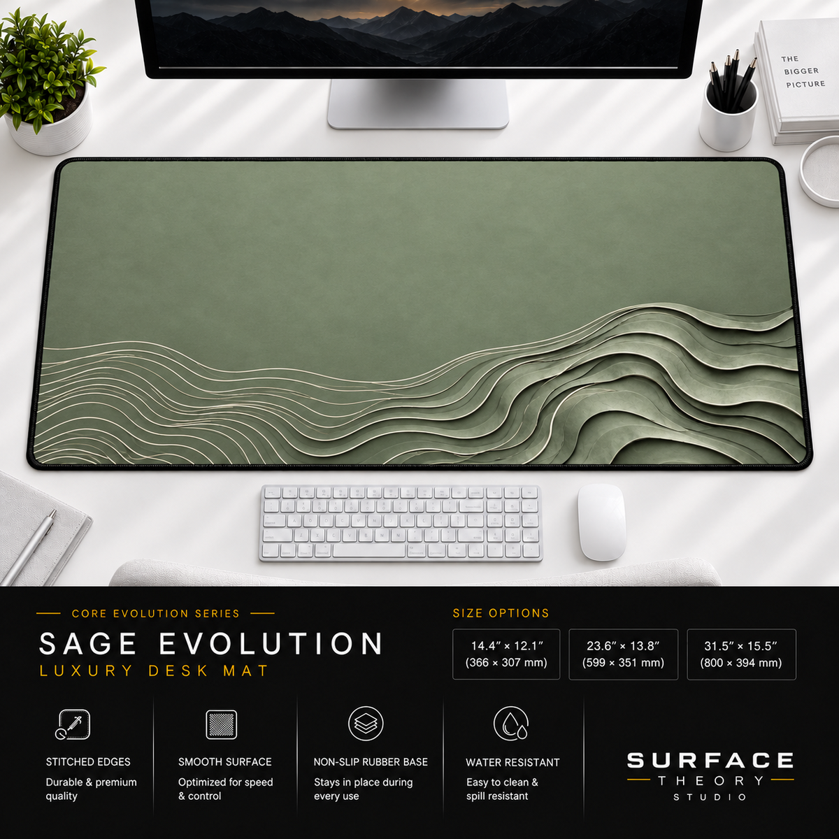 Sage Evolution desk mat beneath a monitor on a bright desk with a white keyboard and mouse.