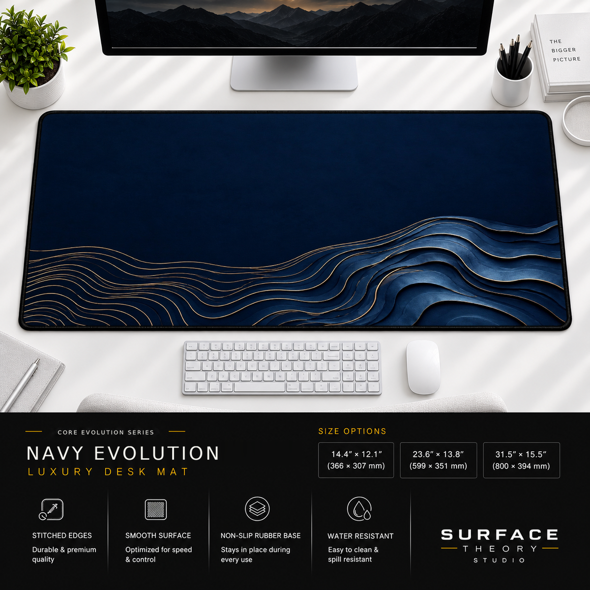 Navy Evolution desk mat beneath a monitor on a bright desk with a white keyboard and mouse.