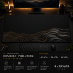 Obsidian Evolution desk mat in a dark workstation with warm monitor lighting.