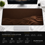 Espresso Evolution desk mat beneath a monitor on a bright desk with a white keyboard and mouse.