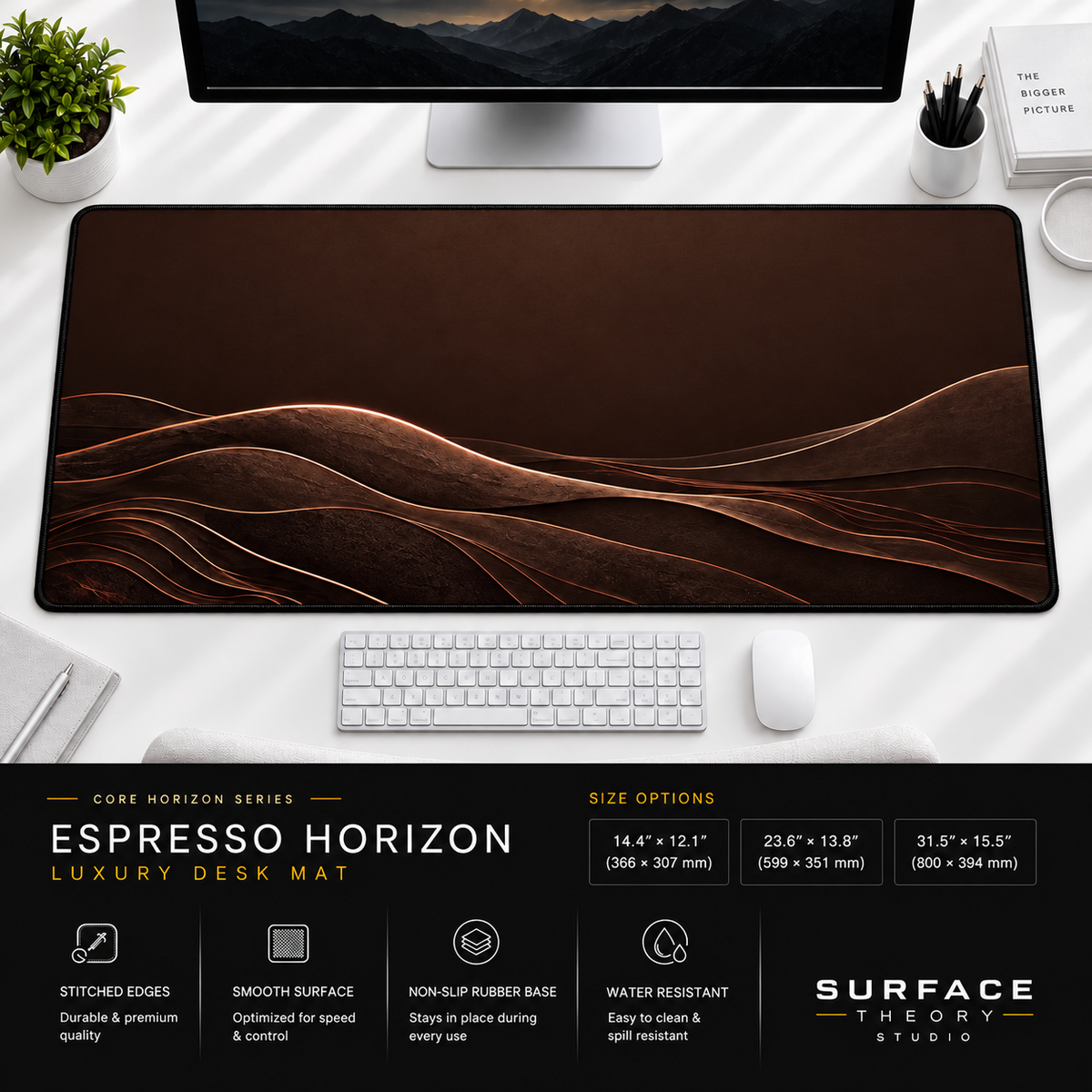 Espresso Horizon desk mat beneath a monitor on a bright desk with a white keyboard and mouse.
