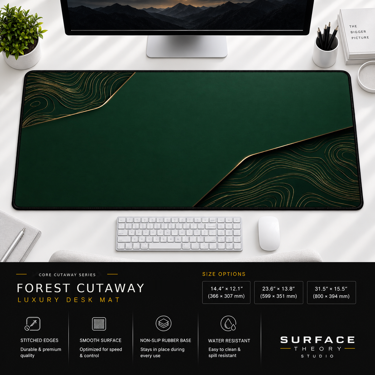 Forest Cutaway desk mat beneath a monitor on a bright desk with a white keyboard and mouse.