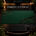 Forest Cutaway desk mat, deep forest green with gold-toned contours in opposing corners, in a warm, dark workspace.