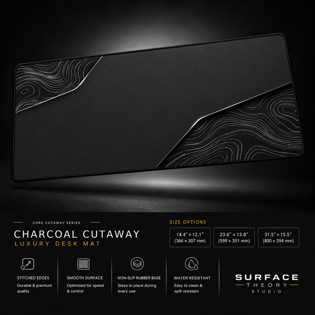 Charcoal Cutaway desk mat floating against a dark studio background.