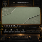 Sage Cutaway desk mat in a gold-toned showcase frame above a keyboard.