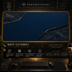 Navy Cutaway desk mat in a gold-toned showcase frame above a keyboard.