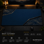 Navy Cutaway desk mat in a dark workstation with warm monitor lighting.