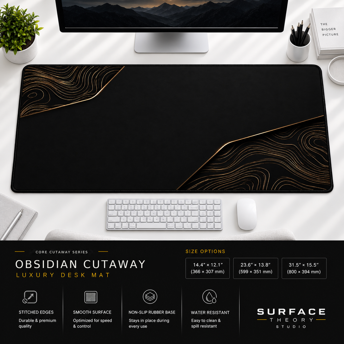 Obsidian Cutaway desk mat beneath a monitor on a bright desk with a white keyboard and mouse.
