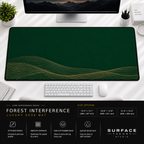 Forest Interference desk mat beneath a monitor on a bright desk with a white keyboard and mouse.