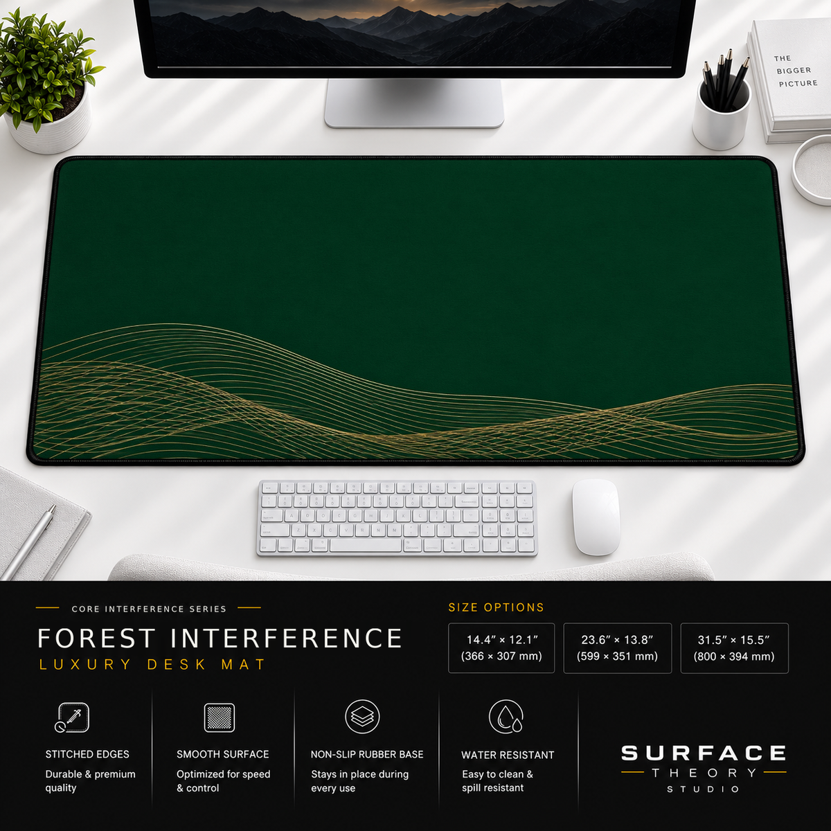 Forest Interference desk mat beneath a monitor on a bright desk with a white keyboard and mouse.