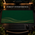 Forest Interference desk mat, deep forest green with overlapping gold-toned curves along the lower edge, in a warm, dark workspace.
