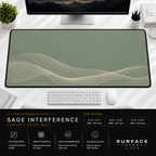 Sage Interference desk mat beneath a monitor on a bright desk with a white keyboard and mouse.