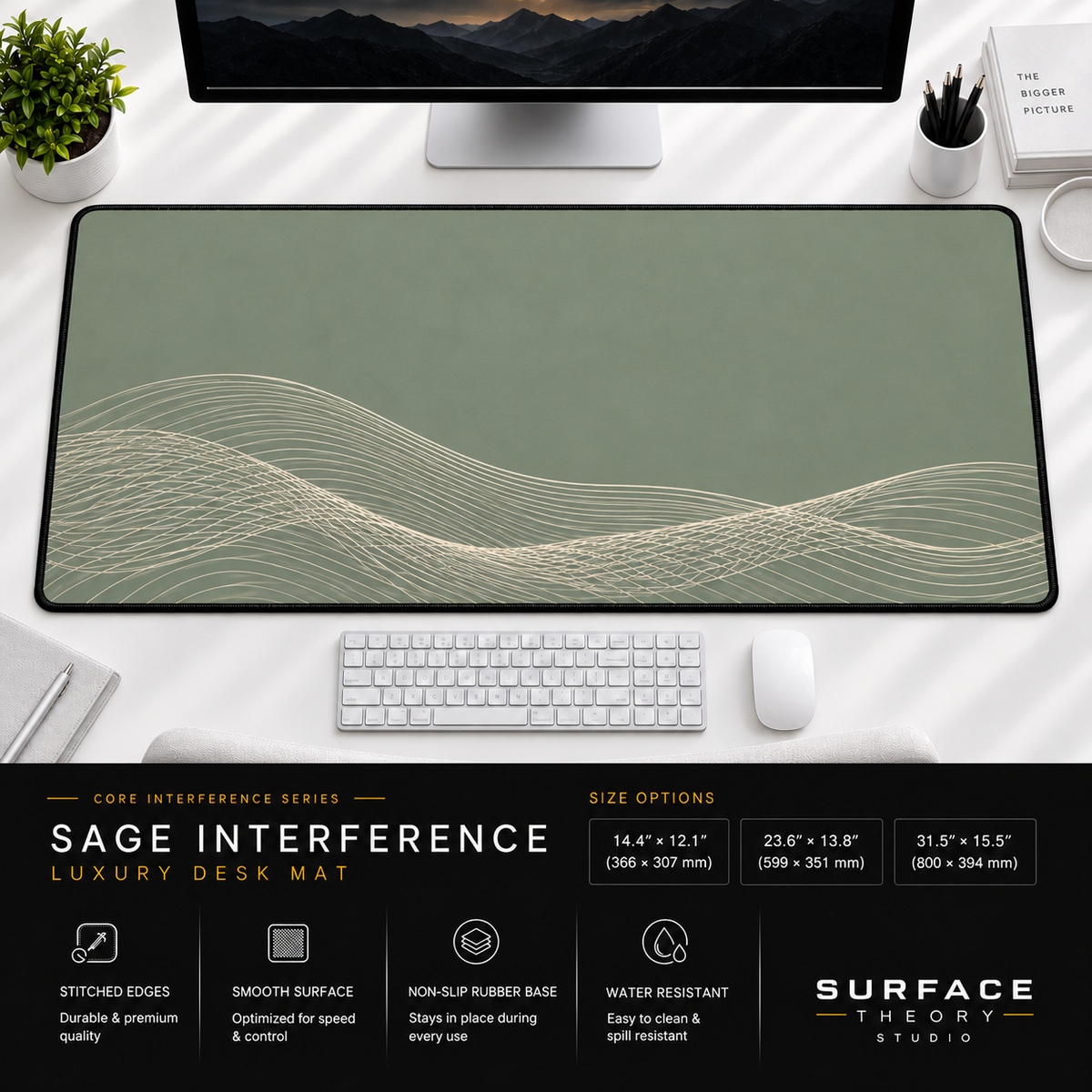 Sage Interference desk mat beneath a monitor on a bright desk with a white keyboard and mouse.