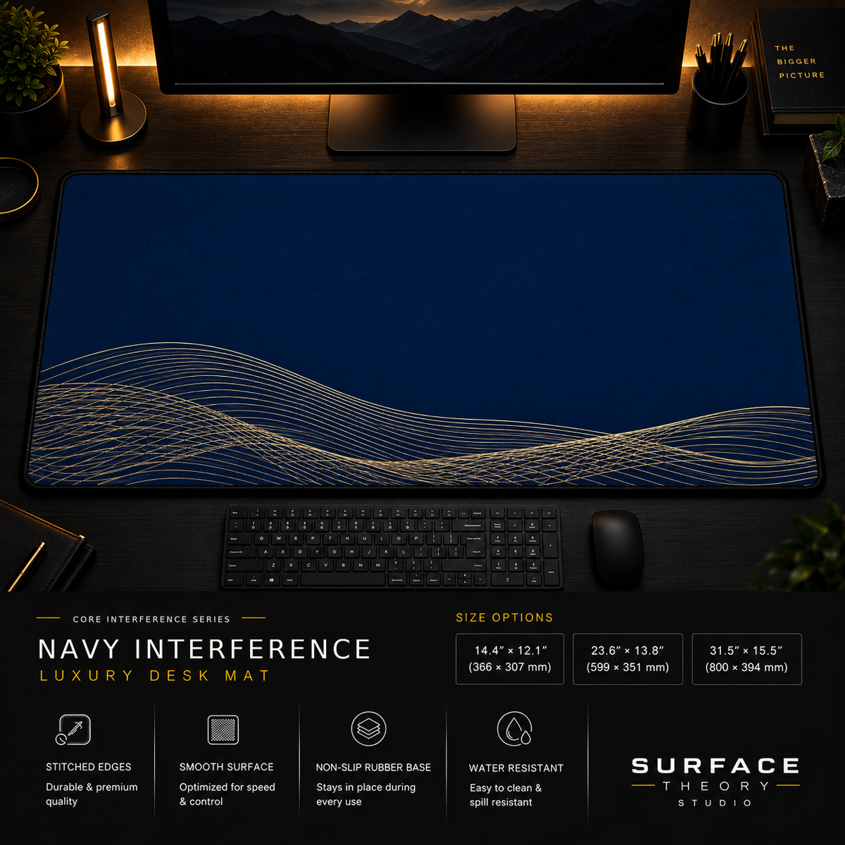 Navy Interference desk mat in a dark workstation with warm monitor lighting.