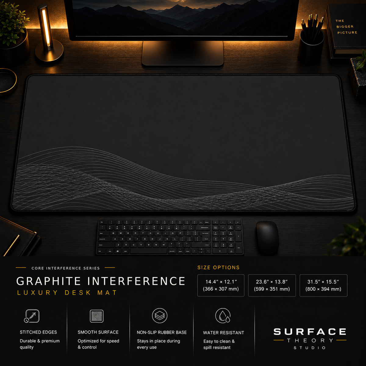Graphite Interference desk mat in a dark workstation with warm monitor lighting.