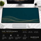 Teal Interference desk mat beneath a monitor on a bright desk with a white keyboard and mouse.