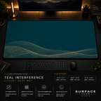 Teal Interference desk mat in a dark workstation with warm monitor lighting.