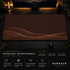 Espresso Interference desk mat in a dark workstation with warm monitor lighting.