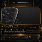 Charcoal Optic desk mat in a gold-toned showcase frame above a keyboard.