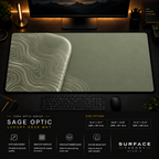 Sage Optic desk mat in a dark workstation with warm monitor lighting.