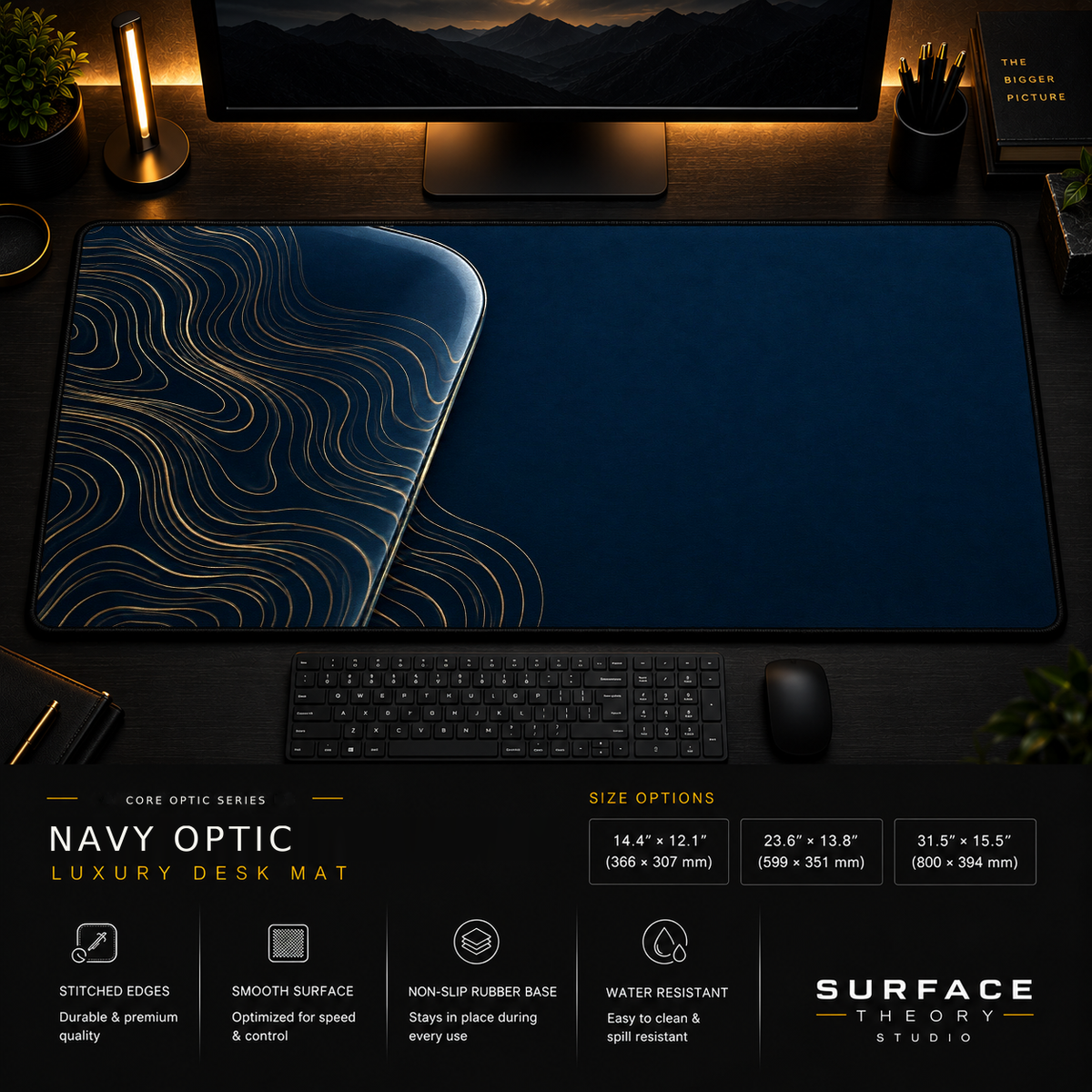 Navy Optic desk mat in a dark workstation with warm monitor lighting.