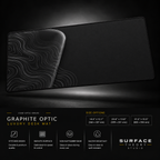 Graphite Optic desk mat floating against a dark studio background.
