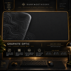 Graphite Optic desk mat in a gold-toned showcase frame above a keyboard.