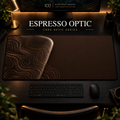 Espresso Optic desk mat, espresso brown with copper-toned contours in a rounded form on the left, in a warm, dark workspace.