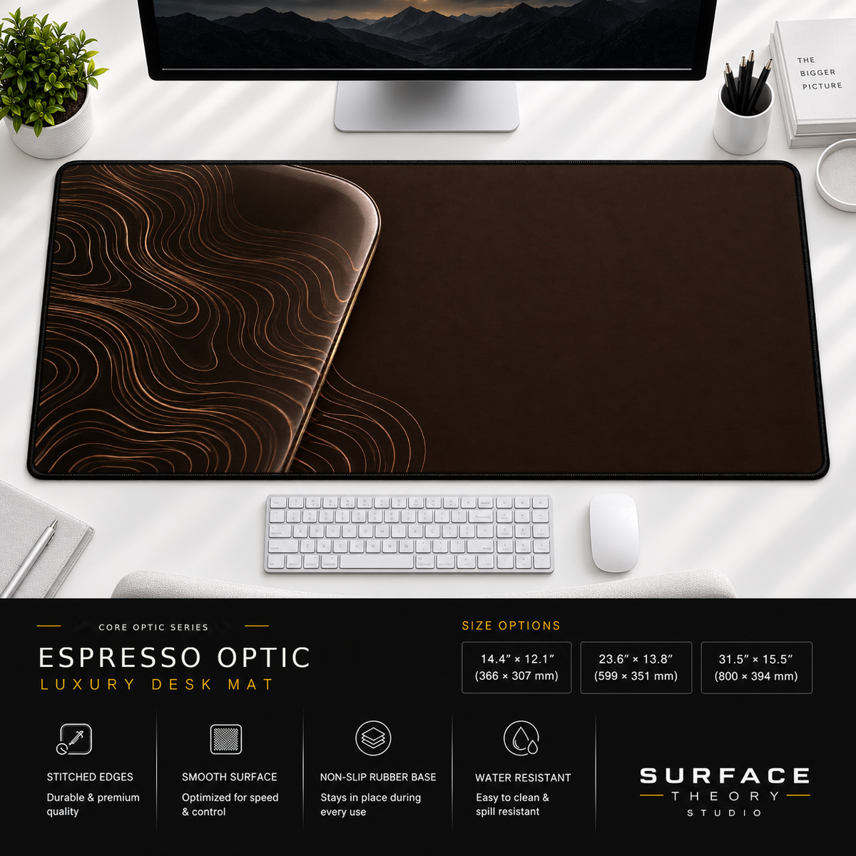 Espresso Optic desk mat beneath a monitor on a bright desk with a white keyboard and mouse.