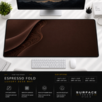 Espresso Fold desk mat beneath a monitor on a bright desk with a white keyboard and mouse.