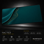 Teal Fold desk mat floating against a dark studio background.