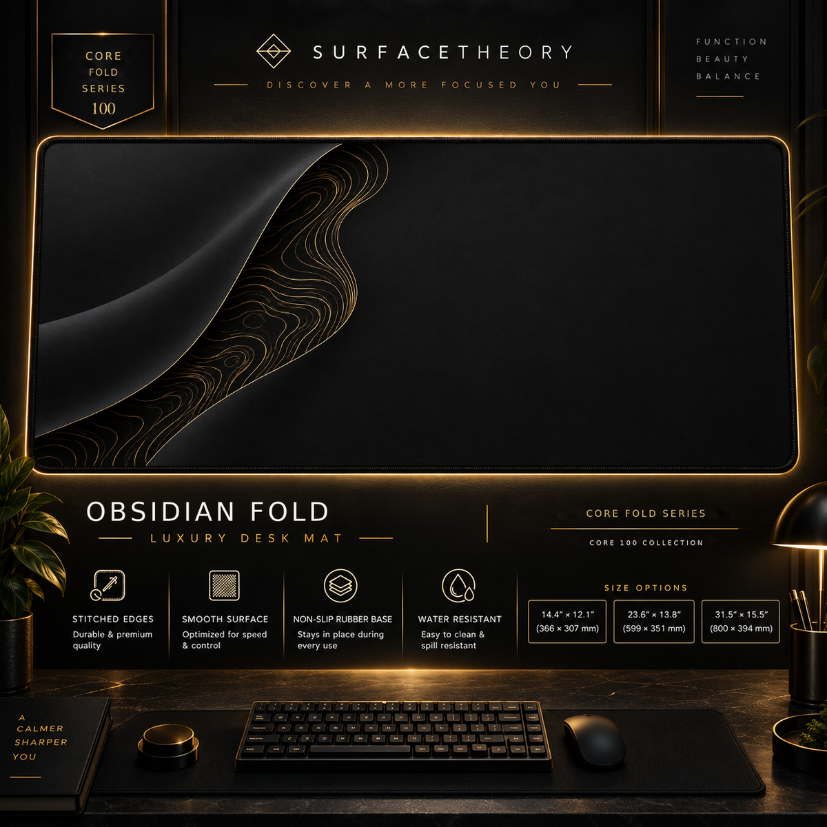 Obsidian Fold desk mat in a gold-toned showcase frame above a keyboard.